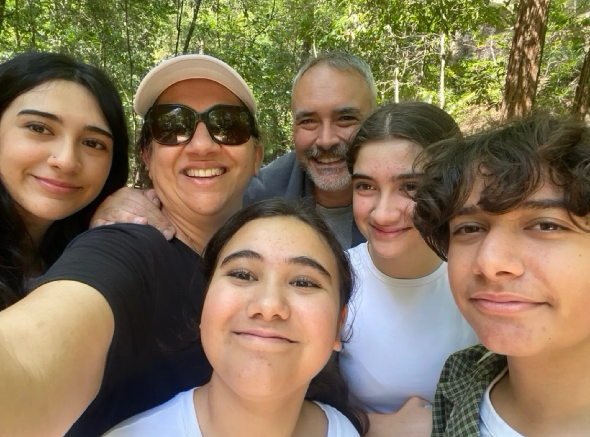 The Price family — four kids and two adults — smiling together at home